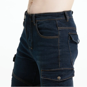 Detail of dark blue motorcycle jeans with side cargo pockets and pleated knee panels