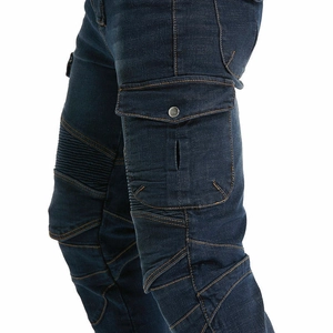Detail of cargo pockets and reinforced pleated knee design on green motorcycle riding jeans