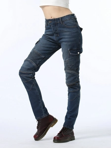 Detail of slim fit dark blue moto denim pants with cargo pockets and knee pleats