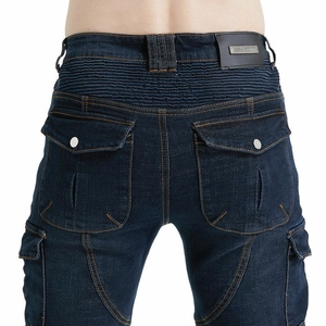Detail of army green biker jeans with accordion stretch panels and cargo pockets