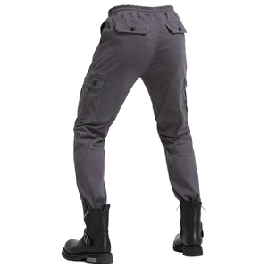 Detail view of the deep gray cargo pants back pockets and durable cotton fabric texture