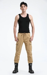 Detail of khaki cargo joggers featuring drawstring waist and tactical side pockets