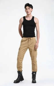Detail of army green men's cargo pants with drawstring waist and large side pockets
