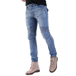Detail of light blue motorcycle jeans featuring ribbed panels and washed denim texture