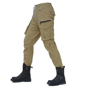 Side view of khaki multi-pocket cargo pants with drawstring waist and moto boots