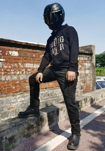 Close-up of LOOSE BIKER printed hoodie with biker jeans and metal-toed leather boots