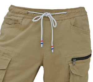 Detail of cargo pants elastic waist with white drawstring and zipper pocket features