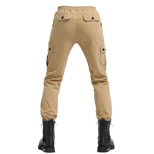 Detail of khaki cargo pants featuring drawstring waist, flap pockets, and elastic cuffs