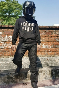Detail of a black biker hoodie with Young Biker text and carbon fiber helmet