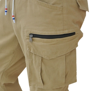 Macro detail of khaki biker pants showing cargo pockets, zippers and colorful drawstrings