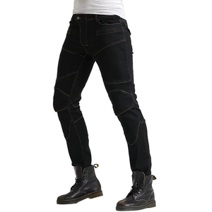 Detail of black motorcycle jeans featuring yellow stitching and pleated knee pads for safety