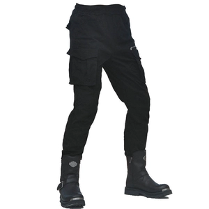 Detail of cargo motorcycle pants with side pockets paired with metal-tip biker boots