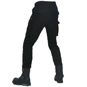 Detail view of black slim-fit motorcycle cargo pants with large side pockets and elastic waist