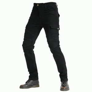 Detail of black motorcycle riding pants showing accordion stretch panels and cargo pockets