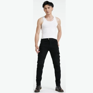 Detail view of black motorcycle pants showing ribbed knee panels and slim fit design