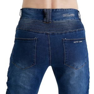 Detail of deep blue motorcycle jeans showing accordion pleated knee and MOTO embroidery