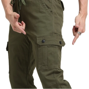 Detailed view of cargo side pocket with button closure on olive green men's joggers