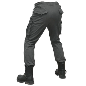 Detail view of motorcycle cargo pants with functional pockets and reinforced fabric texture