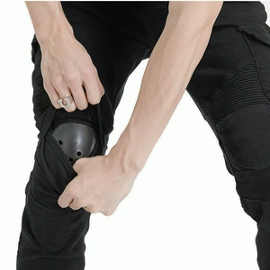 Detail of motorcycle pants featuring accordion stretch panels and removable knee protectors
