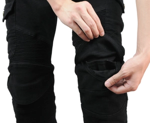Detail of black motorcycle cargo pants showing flexible knee bellows and protector pockets