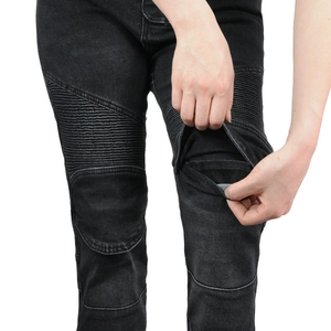 Close-up of flexible accordion panels and protective armor pockets on motorcycle jeans