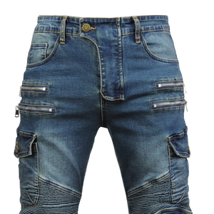Detail of motorcycle cargo jeans with multiple zip pockets and knee pleated stitching