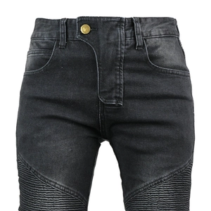 Detail of motorcycle jeans featuring moto-style ribbed panels and golden metal button closure