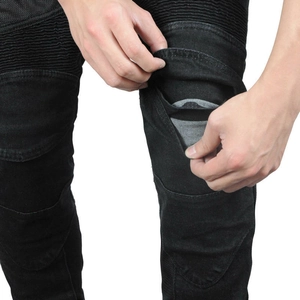 Detail of knee accordion pleats and protective gear pocket on black motorcycle jeans