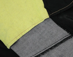 Detail view of motorcycle jeans featuring fluorescent green fabric and double stitching