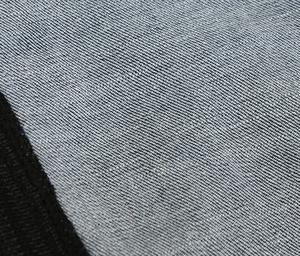 Close-up of breathable mesh fabric and durable denim texture on motorcycle pants