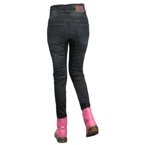 Detail view of motorcycle jeans with accordion panels and brown leather waist patch