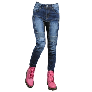 Detail of blue washed motorcycle jeans with pleated knees and decorative side zippers