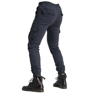 Detail view of cargo riding pants showing multi-pocket design and elastic drawstring waist