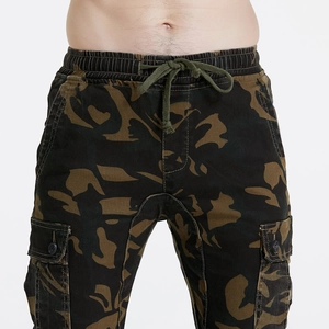 Detail of woodland camo motorcycle pants with cargo pockets and cotton twill texture