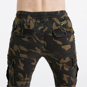 Detail view of camouflage motorcycle pants featuring elastic waist and cargo pockets