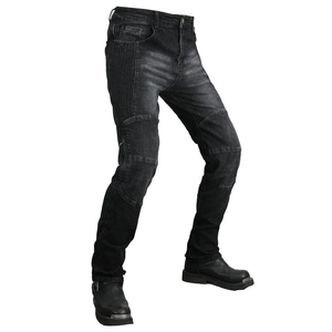 Detail of motorcycle jeans featuring protective knee pleats and heavy denim texture