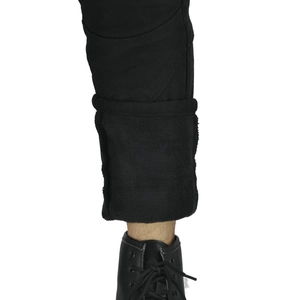 Close-up of motorcycle pants showing thick black fleece lining and folded hem detail