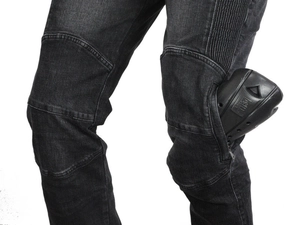 Detail of motorcycle jeans featuring protective knee pads and flexible pleated accordion stretch