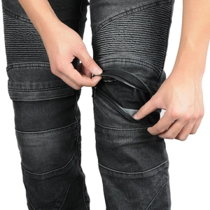Detail of knee zipper pocket on vintage black stretch biker jeans with moto pleats
