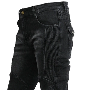 Detail of accordion stretch panels and snap cargo pocket on black motorcycle jeans