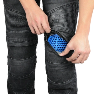 Detail of motorcycle jeans featuring a hidden knee pocket with blue honeycomb armor pad