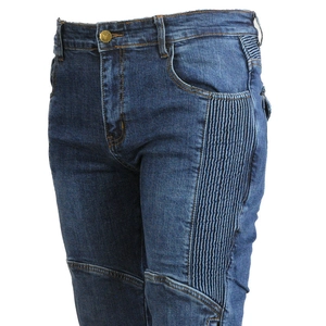 Close-up of deep blue biker jeans featuring accordion stretch panels and metal button