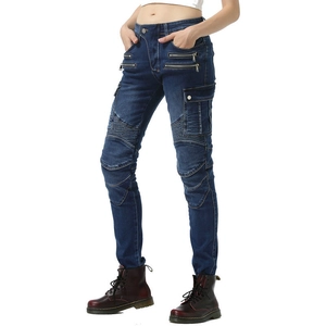 Detail view of motorcycle jeans featuring biker pleats and metallic zippers on dark denim