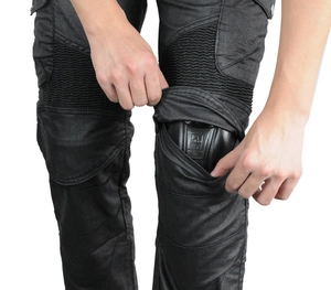 Detail of motorcycle riding pants showing reinforced knee armor and stretch panels