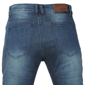 Detail of reinforced stitching and leather logo patch on Volero motorcycle jeans