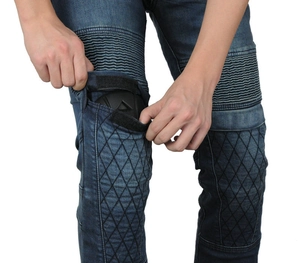 Detail showing removable knee protectors and accordion stretch panels on denim biking pants
