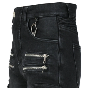 Detail of washed black motorcycle jeans with metallic zippers and side pocket buckle