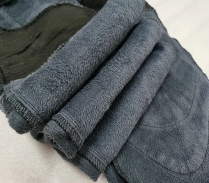 Macro shot of charcoal grey thermal fleece lining with high-density texture and neat edging