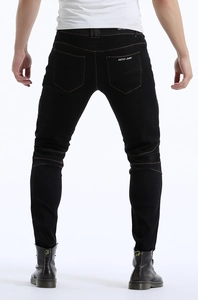 Detail view of motorcycle jeans featuring flexible accordion panels and Moto-jeans embroidery