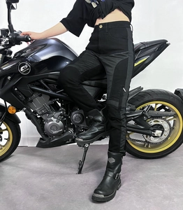 Detail of motorcycle riding jeans with reinforced panels and ergonomic seams on a biker